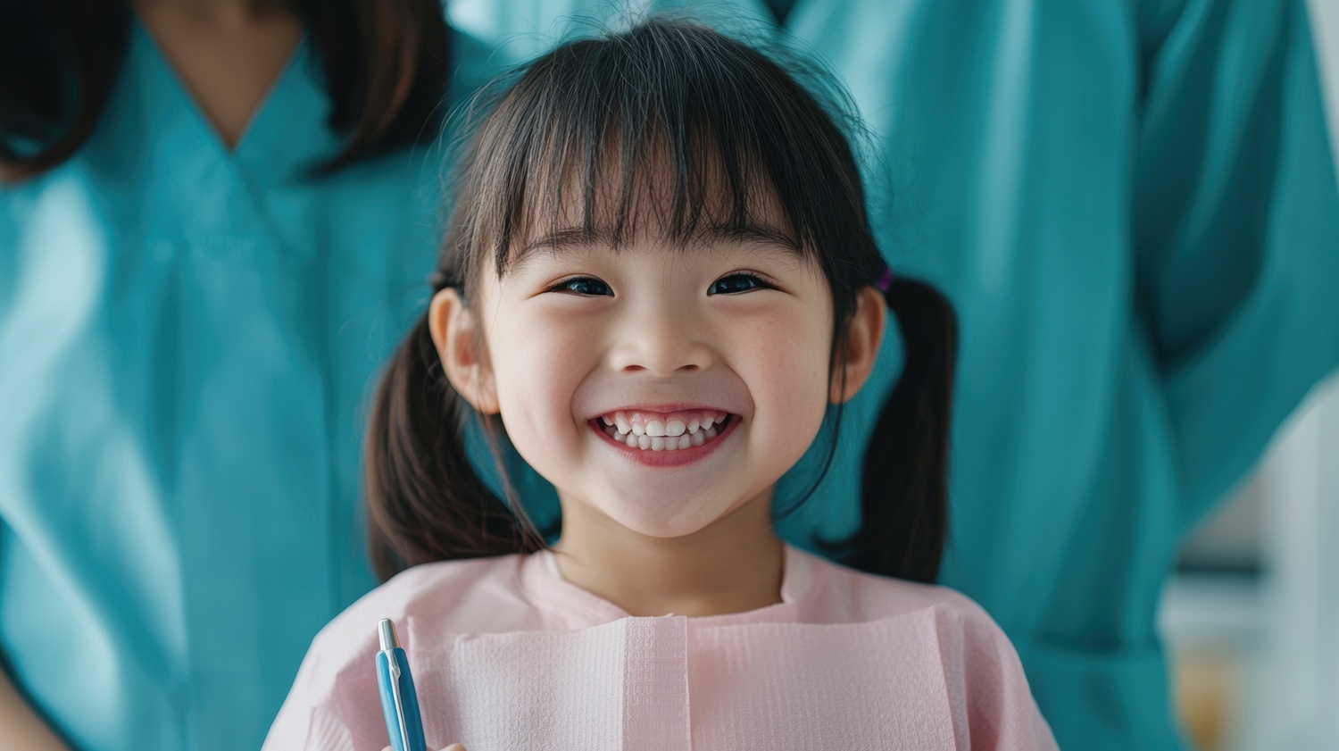A joyful child at a dental clinic, surrounded by supportive parents, showcasing a bright smile and holding dental tools, representing comfort and care in healthcare.
