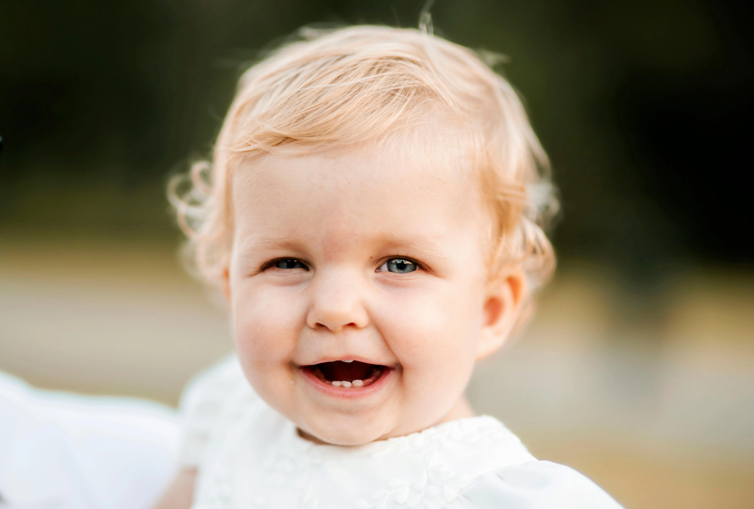 photo-of-a-blonde-baby-wearing-white-smiling_converted