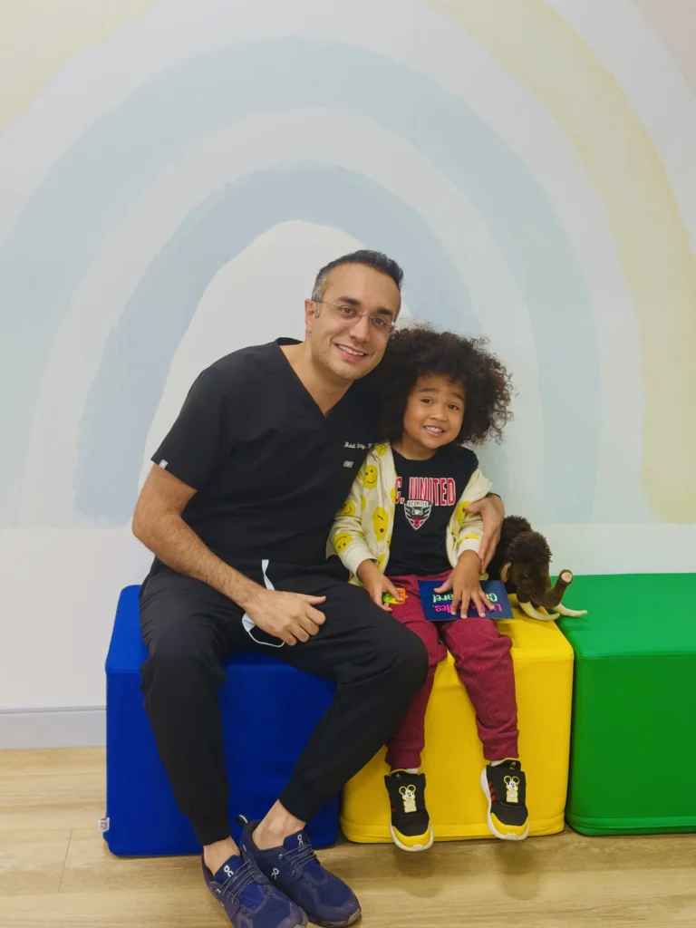 photo of a dentist hugging a child and smiling at ChildSmiles